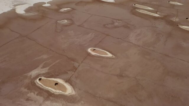 Willcox Playa aerial of strange pattern and textures on a dry lakebed, tilt-up reveal