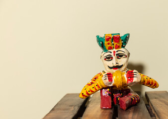 Fototapeta na wymiar Handmade colorful wooden rajasthani musician souvenir with plain background.