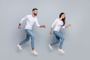 Full body profile photo of cool young brunet couple run wear white shirt jeans shoes isolated on...