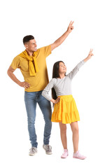 Fototapeta premium Dancing man and his little daughter on white background