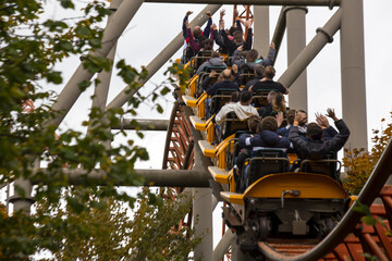 People having fun amazing roller coaster during vacation - obrazy, fototapety, plakaty