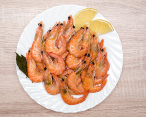 shrimp with lemon on a white plate