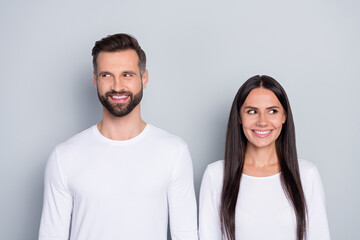 Photo of funny dreamy sister brother wear white shirts looking empty space isolated grey color background