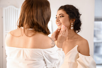 Obraz na płótnie Canvas Makeup artist working with beautiful model in beauty salon