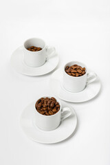 set Perfect small white coffee cup with beautiful ones. roasted coffee beans on white background