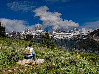 Female hiker in awe of Grand, Middle and South Teton, Wyoming