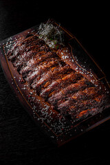 grilled and barbecue ribs pork on dark wooden background
