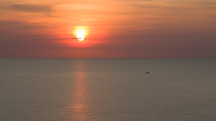 The sun sets at the sea and the orange light suggests reflecting the water in the evening.