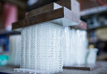 Stacks of glass containers under press for TFT displays