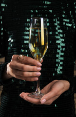 Woman in beautiful dress with glass of champagne, closeup