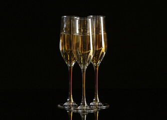 Beautiful glasses with champagne on dark background