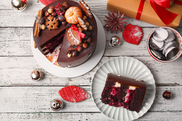 Composition with tasty Christmas chocolate cake on light wooden background
