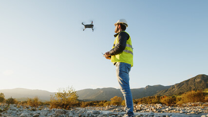 geologist with drone checks the territory - obrazy, fototapety, plakaty