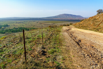 Fototapeta na wymiar Dirt road, Avital Mountain, and the Golan Heights landscape