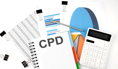 Text CPD on a notebook on the diagram and charts with calculator and pen