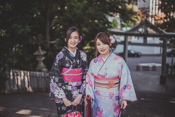 Fototapeta premium Storytelling image of two japanese girls wearing kimono spending time in Tokyo. Traditional clothes lifestyle moments from the local culture in Japan