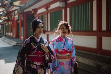 Storytelling image of two japanese girls wearing kimono spending time in Tokyo. Traditional clothes lifestyle moments from the local culture in Japan