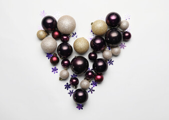 Heart made of beautiful Christmas balls on white background