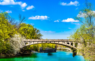 Fototapeta na wymiar Turquoise Isar river and maximilian bridge in Munich - Germany