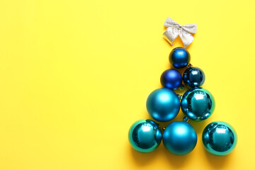 Christmas tree made of balls on yellow background