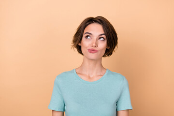 Obraz premium Photo of young pretty woman minded thoughtful look empty space smart isolated over beige color background