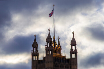 View of Westminster tower in London, flying UK flag at full mask