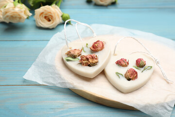 Tray with scented sachets on light blue wooden table