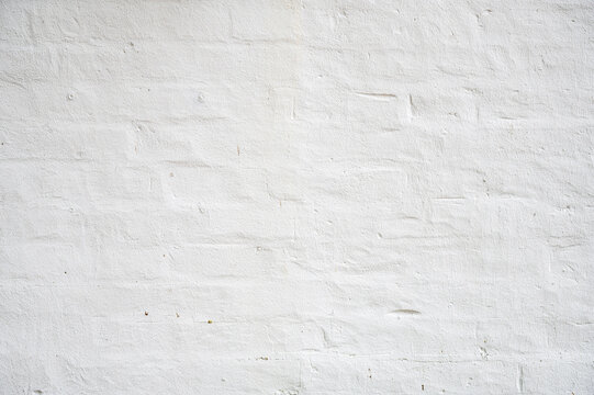 Detail of White gray light damaged rustic brick wall brickwork stonework masonry texture background 