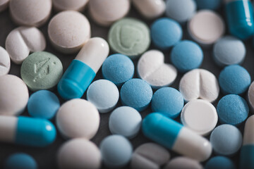 Different type of pills on a a dark background with the copy space. Group of capsules. Concept of medicine.