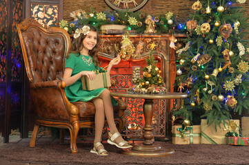 Fototapeta na wymiar happy girl sitting with gift on Christmas