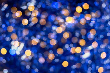 Perfect gold and blue shiny festive bokeh for a New Year and Christmas trend background. Defocused abstract background