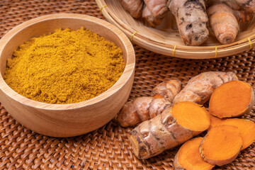 Curry Powder and Turmeric root in wooden plate, Curry Powder on a wooden table background.