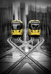 Two Yellow Trams at Stop in Manchester
