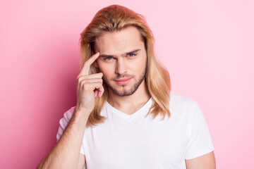 Photo of attractive intelligent young man hold finger temple think idea plan isolated on pink color...