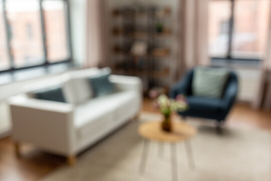 background and interior concept - blurred living room with furniture at home