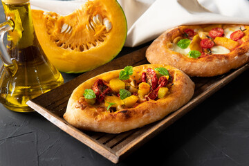 A pie with vegetables on a dark background. Breakfast is an appetizer.