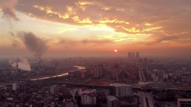 Stunning sunrise timelapse in Skopje city center with factory - drone view