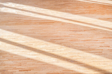Wooden floor futsal, handball, volleyball, basketball, badminton court with natural lighting. Grunge wood pattern texture background, wooden parquet background texture