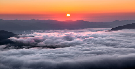Panorama with amazing sunrise. Landscape with high mountains. Fields and meadow are covered with morning fog and dew. Touristic resort Carpathian national park, Ukraine Europe. Natural scenery.