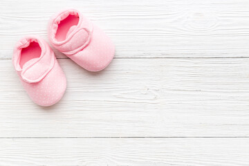 Baby girl pink newborn booties - child birth background