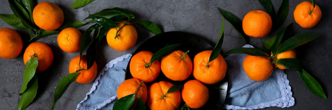 Fresh raw tangerine on dark background, healthy food ingredients