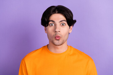 Photo of young happy funny funky amazed shocked face good mood wear orange t-shirt isolated on violet color background