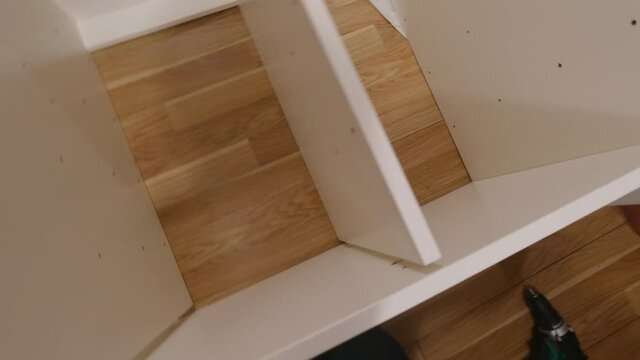 Man assemble furniture point of view indoors