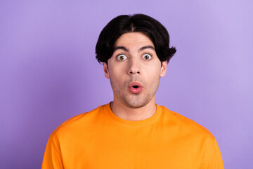 Photo of young happy amazed shocked astonished man reaction news sale isolated on purple color background