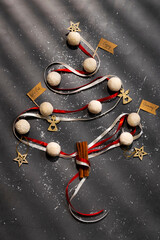 Christmas baking tree background, made from kitchen utensils, cookies, spices, cinnamon sticks, on rustic baking tray, top view