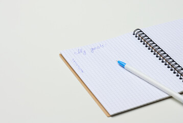 open blank notebook with pen on white table