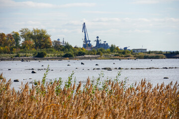 a warship military ship in Kronstadt. reeds and port crane. Gulf of Finland near St. Petersburg....