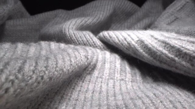 The texture of a soft warm cozy gray woolen knitted sweater