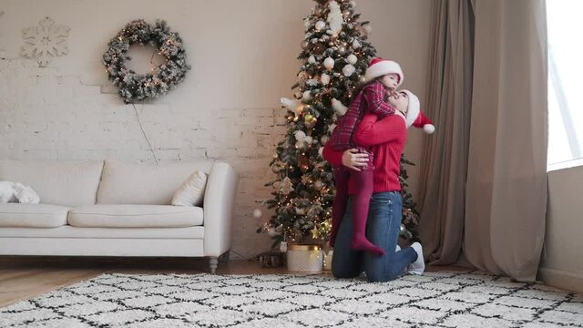  mom little daughter fooling around embrace at home enjoy Christmas holidays