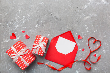 Valentine day composition with Envelope, rose flower and Red heart on table. Top view, flat lay. Holiday concept